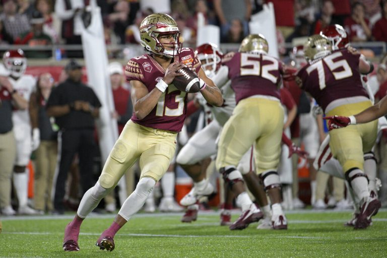 Florida State quarterback Jordan Travis (13) looks for a receiver during the first half of the Cheez-It Bowl NCAA college football game against Oklahoma, Thursday, Dec. 29, 2022, in Orlando, Fla.