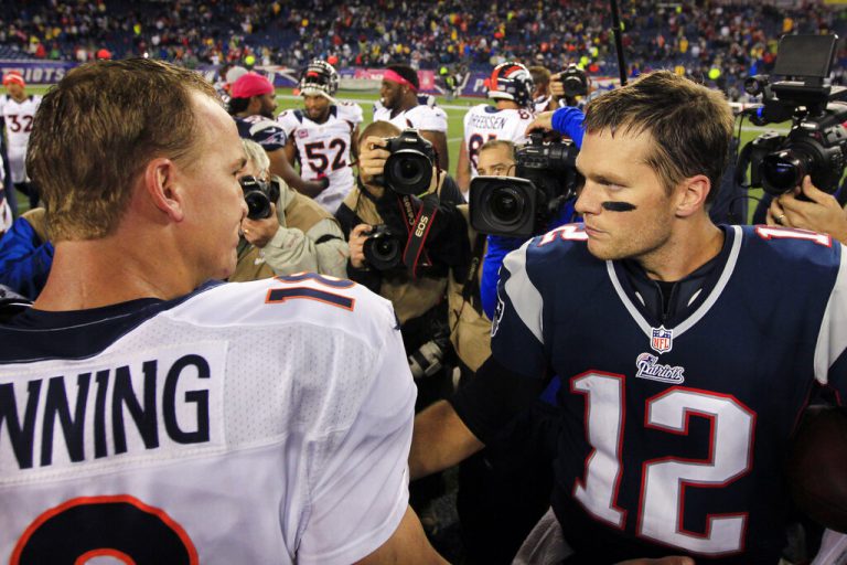 FILE - Denver Broncos quarterback Peyton Manning, left, and New England Patriots quarterback Tom Brady meet after the Patriots' 31-21 win in their NFL football game on Oct. 7, 2012, in Foxborough, Mass. Brady, the seven-time Super Bowl winner with New England and Tampa Bay, announced his retirement from the NFL on Wednesday, Feb. 1, 2023 exactly one year after first saying his playing days were over. He leaves the NFL with more wins, yards passing and touchdowns than any other quarterback.