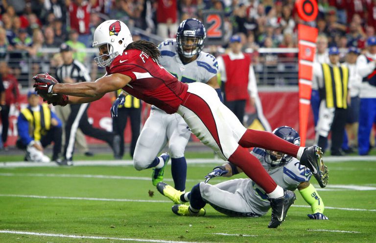 Arizona Cardinals wide receiver Larry Fitzgerald (11) scores a touchdown against the Seattle Seahawks during the first half of an NFL football game, Sunday, Jan. 3, 2016, in Glendale, Ariz.