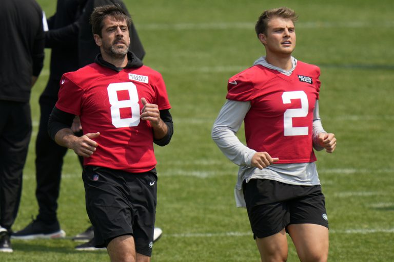 FILE - New York Jets quarterbacks Aaron Rodgers, left, and Zach Wilson warm-up at the NFL football team's training facility in Florham Park, N.J., Tuesday, June 6, 2023. Wilson said his struggles the past two seasons has humbled him, but he's "psyched" about working with and learning from Rodgers, the player he idolized as a kid. Rodgers says Wilson has been "incredible" this offseason.