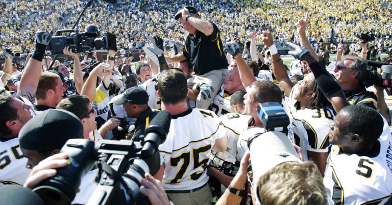 In this Sept. 1, 2007, file photo, Appalachian State coach Jerry Moore is carried off the field at Michigan Stadium by his players after they upset No. 5 Michigan 34-32 in an NCAA college football game in Ann Arbor, Mich. For the first time a ranked major college team had lost to a team from the lower tier of Division I. But as Appalachian State reminded us all a few years back, you never know when a classic is about to break out.